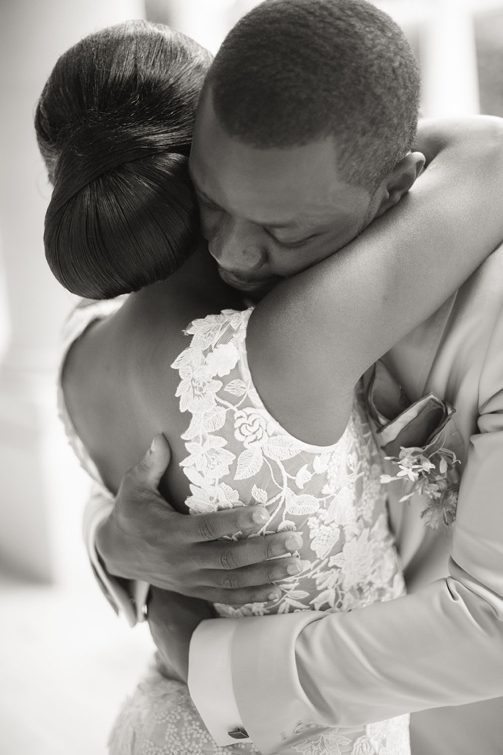 the groom hugs his wife